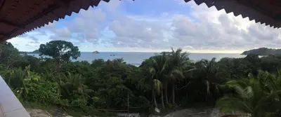 a view of the ocean from a resort at Hotel Coco Beach in Manuel Antonio