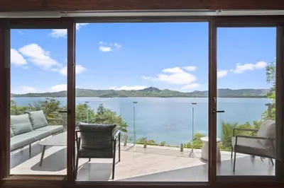 a view of the water from a house with sliding glass doors at 5-BD Beachfront, Ocean-View Hillside Home in Playa Flamingo
