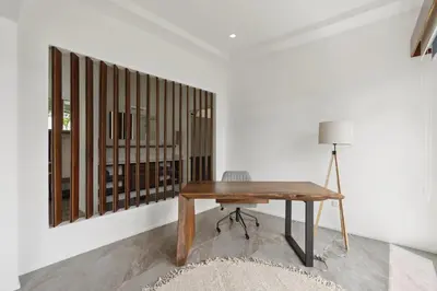 a room with a wooden table and a chair at 5-BD Beachfront, Ocean-View Hillside Home in Playa Flamingo
