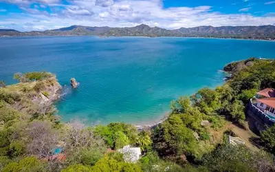 an aerial view of a large body of water at 5-BD Beachfront, Ocean-View Hillside Home in Playa Flamingo