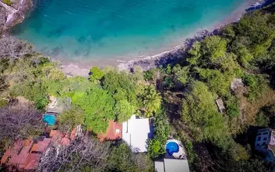 an aerial view of a house and the ocean at 5-BD Beachfront, Ocean-View Hillside Home in Playa Flamingo