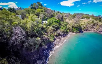 an aerial view of a beach and the ocean at 5-BD Beachfront, Ocean-View Hillside Home in Playa Flamingo