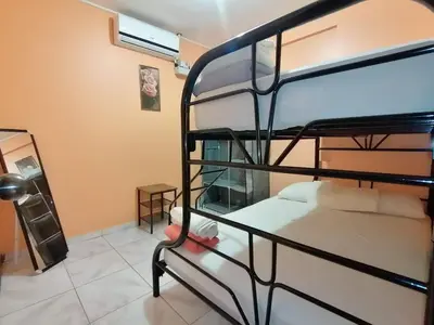 a bedroom with two bunk beds in a room at Marta's Guesthouses, apartamentos con entrada autonoma in Puerto Limón