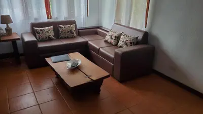 a living room with a couch and a coffee table at La Casita de Naomi in Tamarindo
