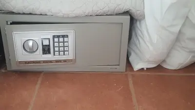 a small television sitting on the floor next to a bed at La Casita de Naomi in Tamarindo
