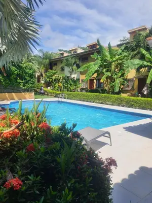 a swimming pool in front of a villa at La Casita de Naomi in Tamarindo