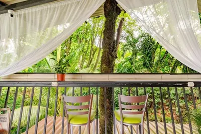 two chairs sitting on a balcony with a window at Rio Danta in Fortuna