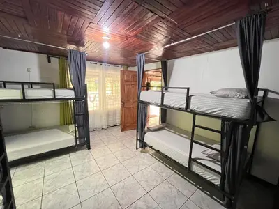 a room with three bunk beds in it at Rio Danta in Fortuna