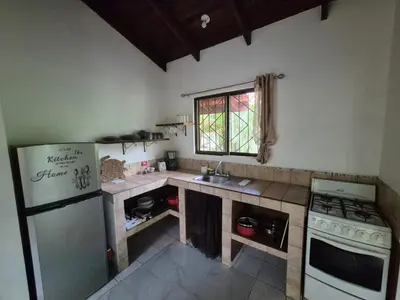 a kitchen with a refrigerator and a stove and a sink at Villasjungle 3 in Sámara