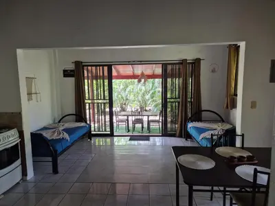 a living room with a door open to a patio at Villasjungle 3 in Sámara