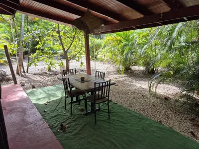 a wooden table and chairs on a patio at Villasjungle 3 in Sámara