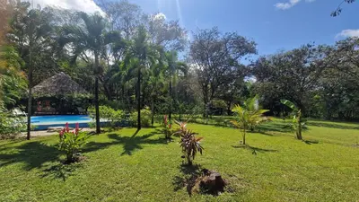 a garden with a swimming pool and a resort at Villasjungle 3 in Sámara