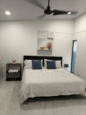 a bedroom with a large bed with a ceiling fan at MADRE TERRA in Uvita