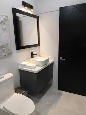 a bathroom with a sink and a toilet and a mirror at MADRE TERRA in Uvita