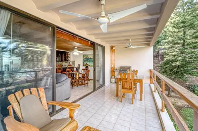 a screened in porch with chairs and a table at Flamingo Marina Resort 413 in Playa Flamingo