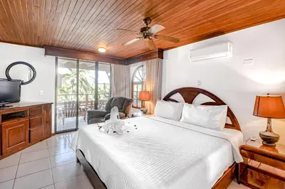 a bedroom with a large bed and a television at Flamingo Marina Resort 413 in Playa Flamingo