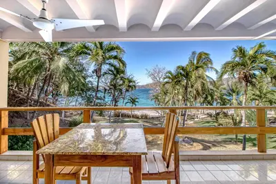 a dining room with a view of the ocean at Flamingo Marina Resort 413 in Playa Flamingo