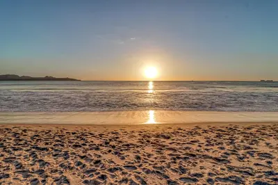 a sunset on a beach with the ocean at Flamingo Marina Resort 413 in Playa Flamingo
