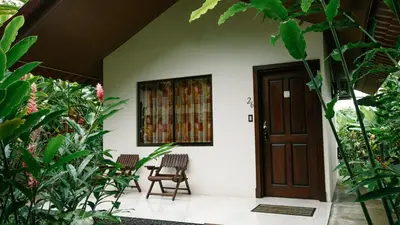 a front door of a house with plants at Orquideas Boutique Hotel in Fortuna