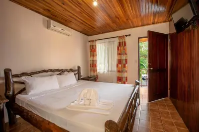 a bedroom with a bed with a hat on it at Orquideas Boutique Hotel in Fortuna