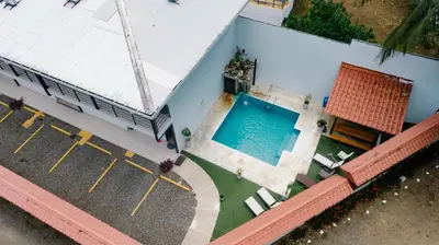 an overhead view of a house with a swimming pool at Apartamentos Ganesha Jacó in Jacó