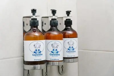 a group of four bottles of wine on a wall at Apartamentos Ganesha Jacó in Jacó