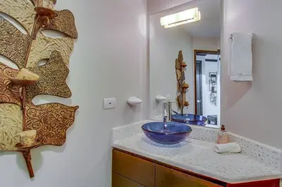 a bathroom with a blue bowl sink and a mirror at Luxury Oceanfront Stay, Two Master Suites, Walk to Town in Jacó
