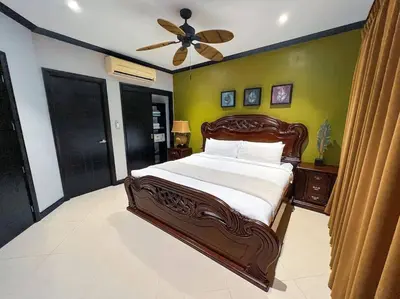 a bedroom with a bed and a ceiling fan at Luxury Oceanfront Stay, Two Master Suites, Walk to Town in Jacó