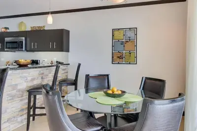 a kitchen and dining room with a table and chairs at Luxury Oceanfront Stay, Two Master Suites, Walk to Town in Jacó