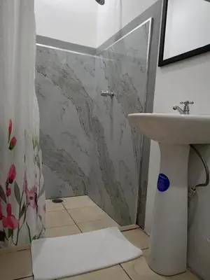 a bathroom with a shower and a sink at Hotel Cañas in Cañas