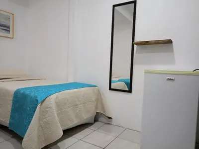 a bedroom with a bed and a mirror on the wall at Hotel Cañas in Cañas