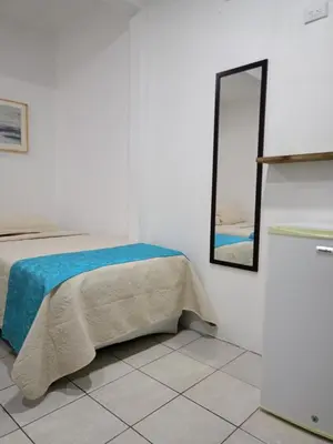 a bedroom with a bed and a mirror on the wall at Hotel Cañas in Cañas