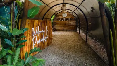 a tunnel in a building with a sign on the wall at Seren Glamping in Uvita