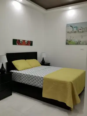 a bedroom with a large bed with a yellow blanket at 935 Lodge San José in San José