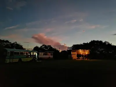 a bus parked in front of a building at sunset at Combi Bus Dreamcatcher in Sarchí
