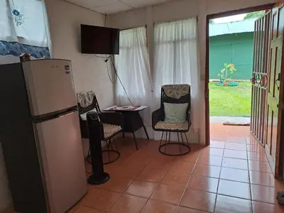 a kitchen with a refrigerator and a table and chairs at Casa Los Ángeles in Ángeles