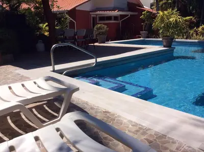 a swimming pool with two lounge chairs next to it at Villas Casa Carlos in La Abuela