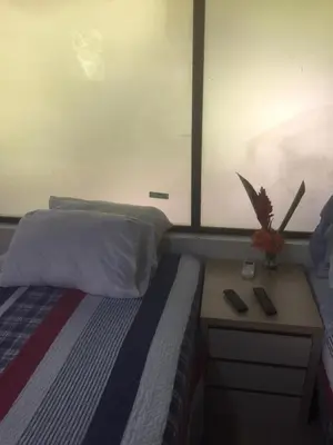 a bedroom with a bed and a nightstand with two remote controls at Villas Casa Carlos in La Abuela
