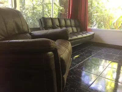 a living room with two leather chairs and a couch at Villas Casa Carlos in La Abuela