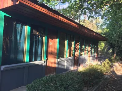 a house with colorful windows on the side of it at Hotel y restaurante Maktub in Nandayure