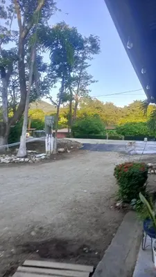 a view of a parking lot with trees and bushes at Hotel y restaurante Maktub in Nandayure