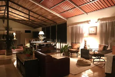 a large living room with a table and chairs at Casa Zu in San Pedro