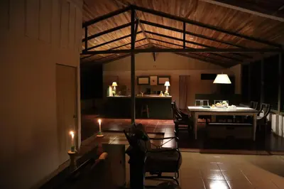 a living room with a table and chairs and candles at Casa Zu in San Pedro
