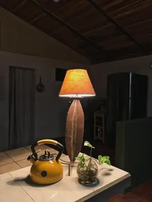a lamp sitting on top of a table with a tea kettle at Casa Zu in San Pedro