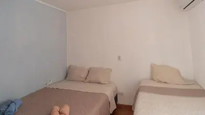 a room with two beds and a person sitting on a bed at Pura Vida Villa! Beachfront Golf and Country Club Los Delfines 24 hours security in Tambor