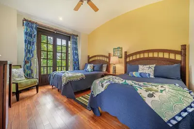 a bedroom with two beds and a window at Dream House in prestigious Hacienda Pinilla in Tamarindo