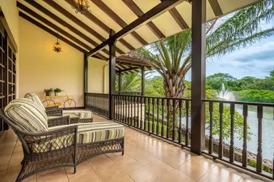 a screened in porch with a view of the water at Dream House in prestigious Hacienda Pinilla in Tamarindo