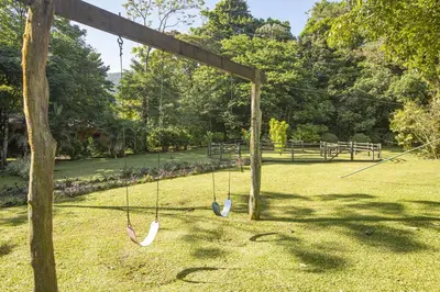 two swings in a yard with a park at Beautiful 2 Bedroom Villa with Private Nature Reserve - Friendship House in Bijagua