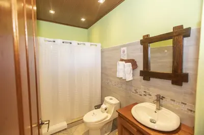 a bathroom with a shower and a toilet and a sink at Beautiful 2 Bedroom Villa with Private Nature Reserve - Friendship House in Bijagua