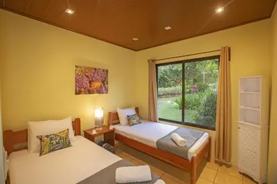 a bedroom with two beds and a window at Beautiful 2 Bedroom Villa with Private Nature Reserve - Friendship House in Bijagua